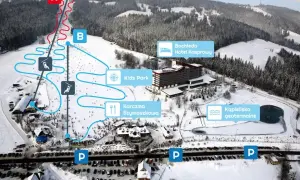 Widok na zimowe **doliny w Tatrach** z trasami narciarskimi, hotelem, karczmą i kąpieliskiem geotermalnym.