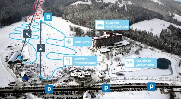 Widok na zimowe **doliny w Tatrach** z trasami narciarskimi, hotelem, karczmą i kąpieliskiem geotermalnym.