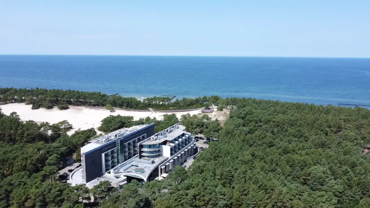 Nowoczesne apartamenty nad morzem z basenem, otoczone sosnowym lasem, z widokiem na spokojne, błękitne morze.