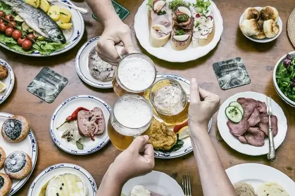 Uczta w stylu kuchnia czeska: ryba, kiełbasa, sery, piwo i przekąski.